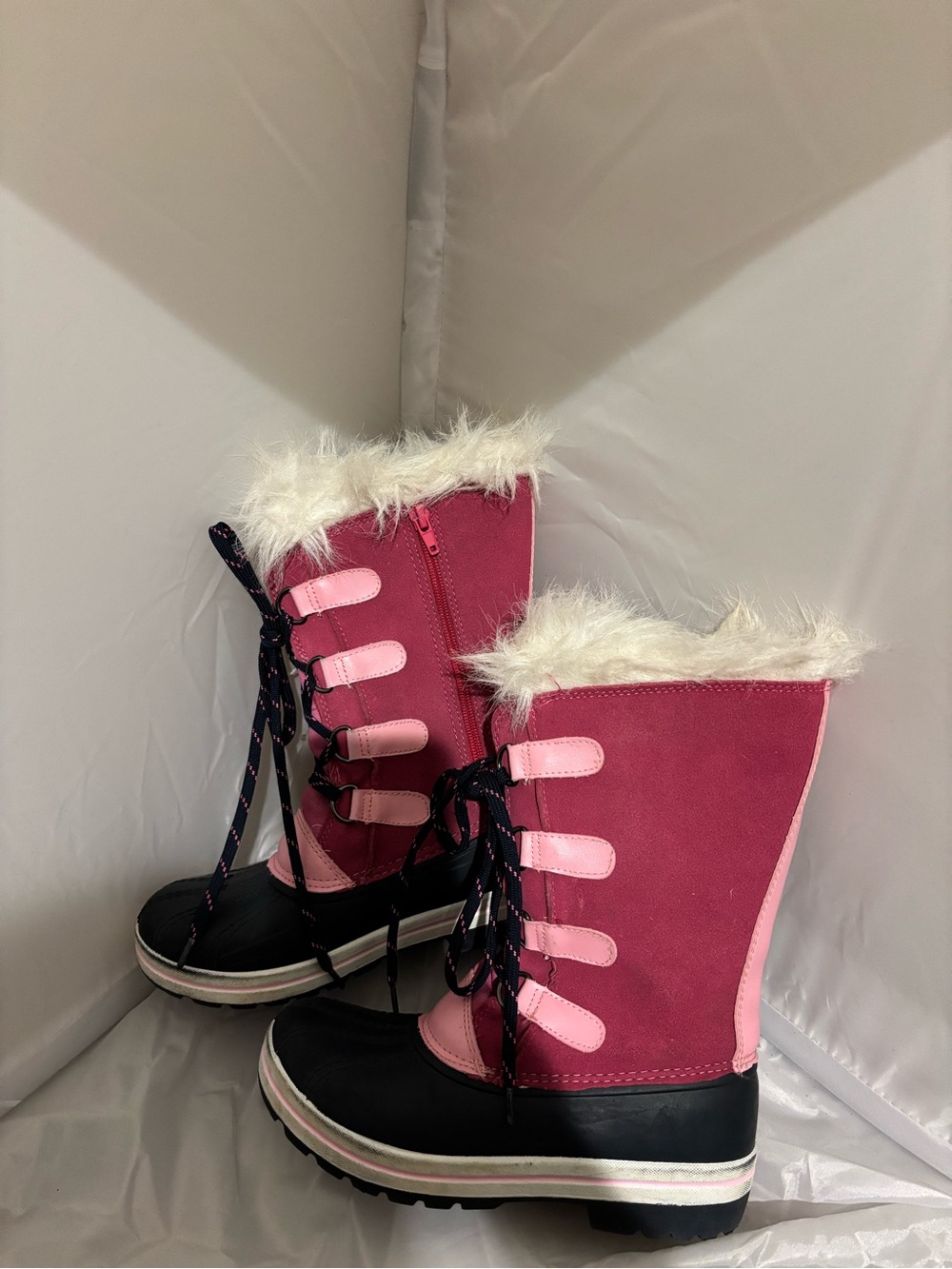The image shows the black rubber lug outsole of an Ozark Trail kids' winter boot